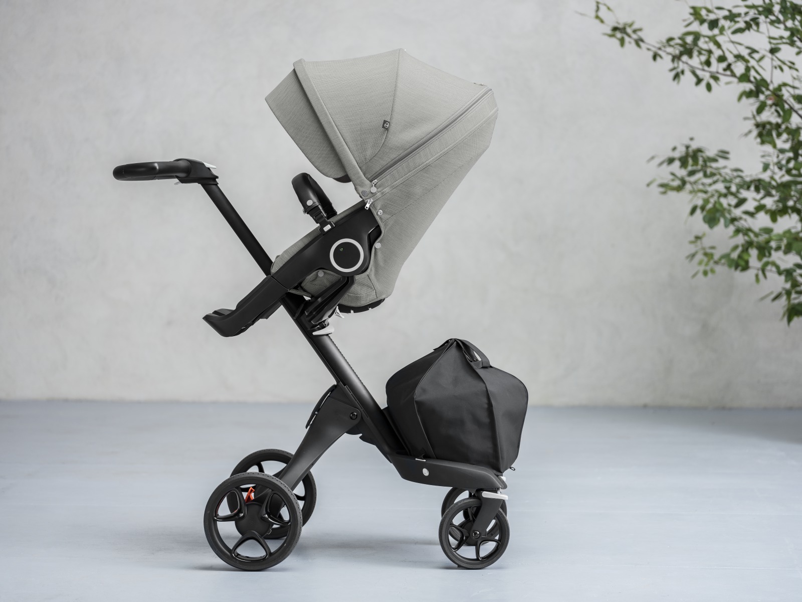 StokkeÂ® XploryÂ® with Black Chassis and StokkeÂ® Stroller Seat, Brushed Grey.